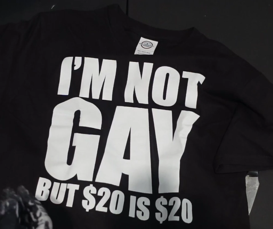 a black t-shirt with the words 'im not gay but 20$ is 20$'